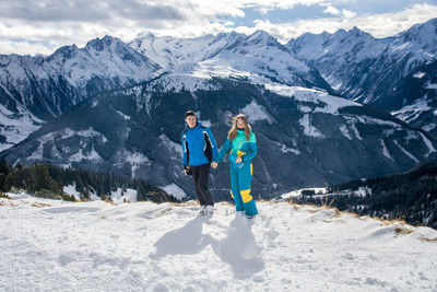 Rear view of woman standing on snow covered mountain