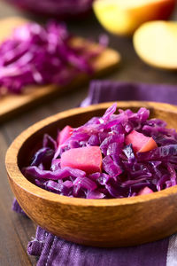 Close-up of purple roses in bowl on table