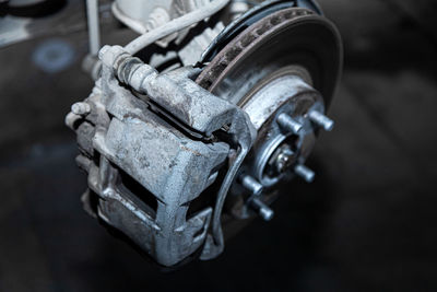 Close-up of a car hub, brake caliper, brake pads, brake disc, wheel bearing prepared for repair. 