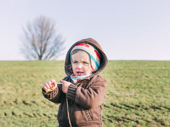 Girl on field against sky