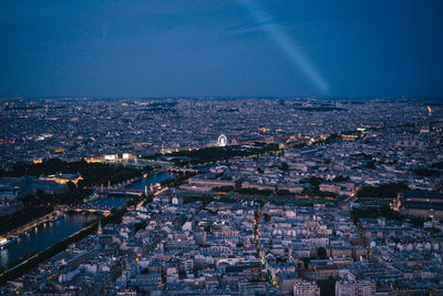 High angle view of illuminated cityscape against sky at night