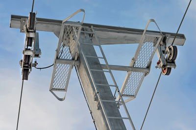 Low angle view of crane against sky