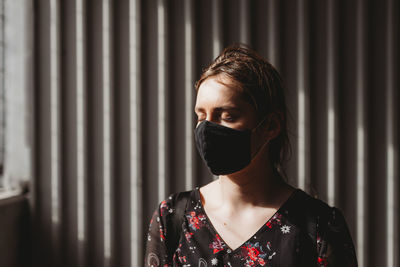 Depressed woman with face mask closed eyes on the sun