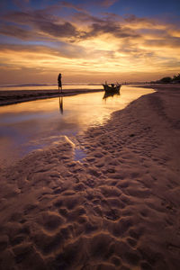 Scenic view of beach against sky during sunset