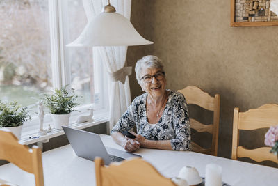 Senior woman sitting at dining table