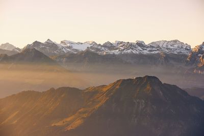 Scenic view of snowcapped mountains against clear sky