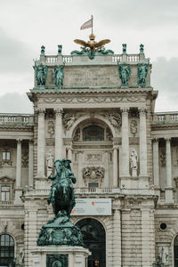 Low angle view of statue against historic building