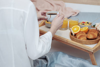 Romantic breakfast with coffee, waffles, orange juice and rose flowers.