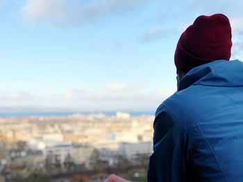 Rear view of man standing against sky