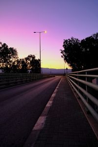 Street against sky at sunset