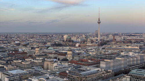 Aerial view of city against cloudy sky