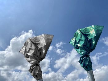 Low angle view of umbrella against blue sky