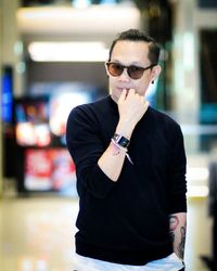 Young man wearing sunglasses standing outdoors
