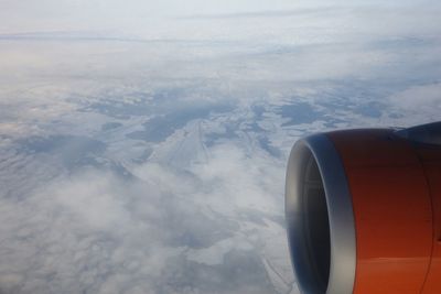 Cropped image of airplane flying over landscape