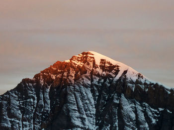 Snowcapped mountain against sky during sunset