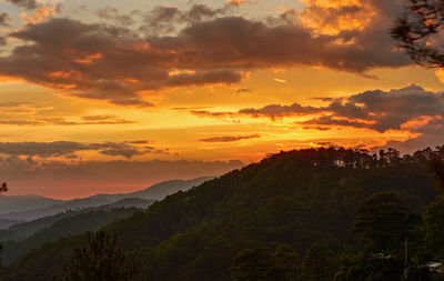 Scenic view of mountains against romantic sky during sunset