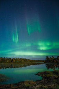 Scenic view of lake against sky at night