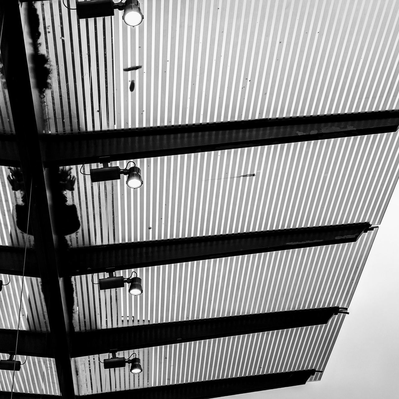 LOW ANGLE VIEW OF METAL GRATE ON BUILDING