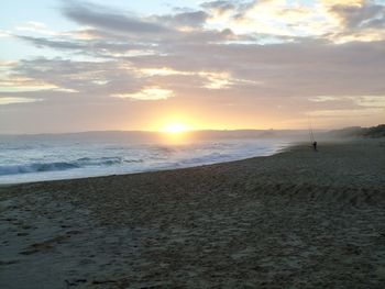 Scenic view of beach against sky during sunset