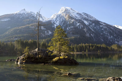 Scenic view of lake and mountains against sky