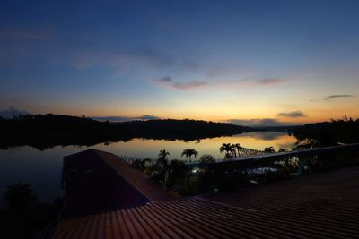 Scenic view of house against sky at sunset