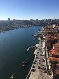 High angle view of buildings by sea against clear sky