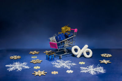 Close-up of christmas decoration on table against blue background