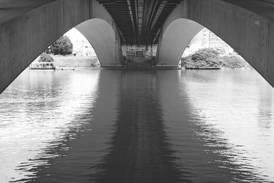 Arch bridge over river against sky