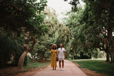 Full length of couple standing on footpath