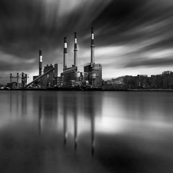 Long exposure of reflection of factory in sea