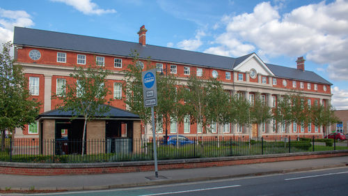 Road by building against sky