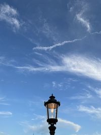 Low angle view of street light against blue sky