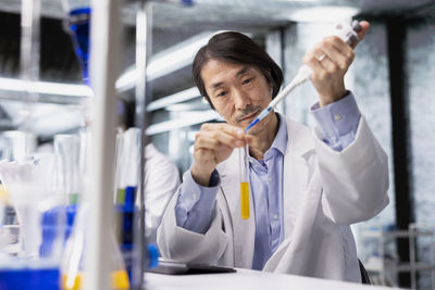 Side view of young woman drinking glass