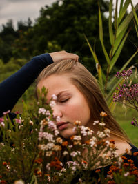 Close-up of woman with flowers in park