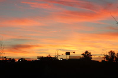 Silhouette of built structure at sunset