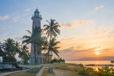 View of statue at seaside during sunset
