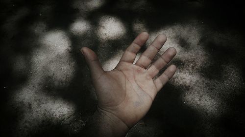 Close-up of human hand against blurred background