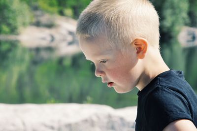 Close-up portrait of boy looking away outdoors