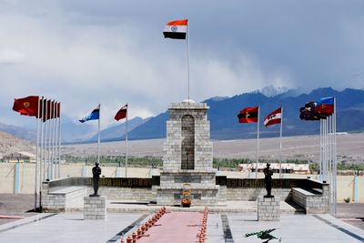 Flag in city against sky