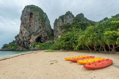 Scenic view of rocks on beach against sky