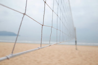 Close-up of volley ball net on beach