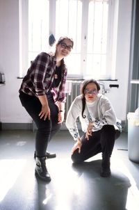 Side view of mother and daughter walking on floor