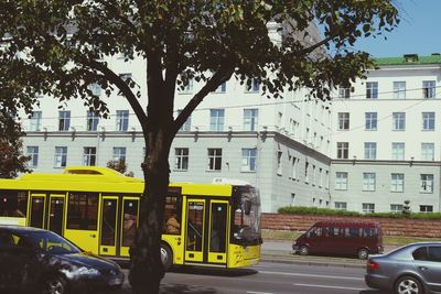 Cars on road against buildings in city