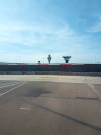 Airplane on airport runway against sky