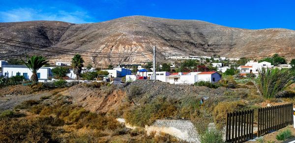 Panoramic view of houses and buildings against sky