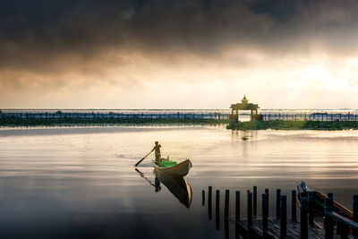 View of boat in sea against cloudy sky