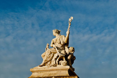 Low angle view of statue against blue sky