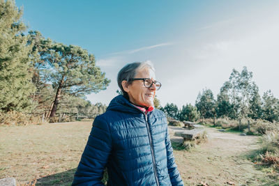 Young man standing against mountain