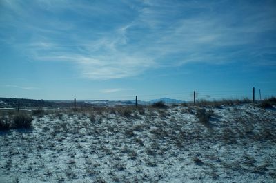 Snow covered field against sky