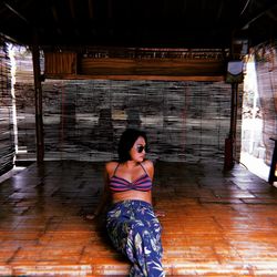 Woman sitting on wooden floor